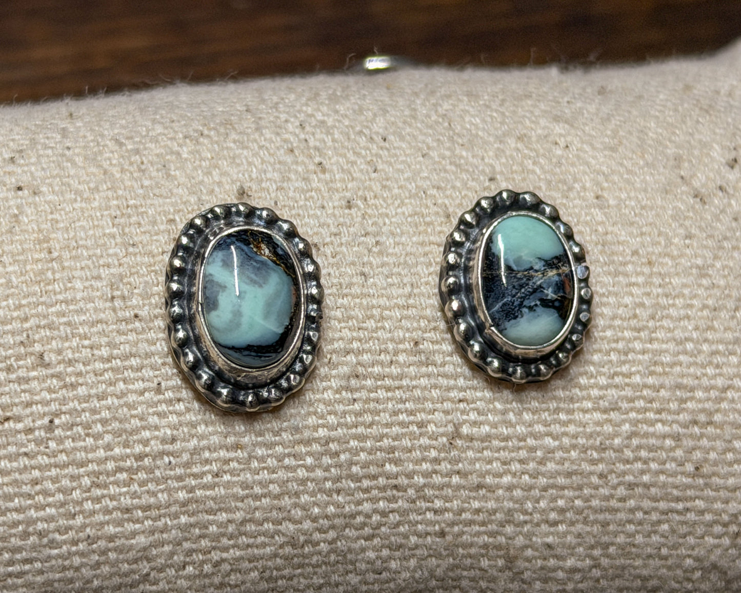Oval White Buffalo turquoise earrings, detail view