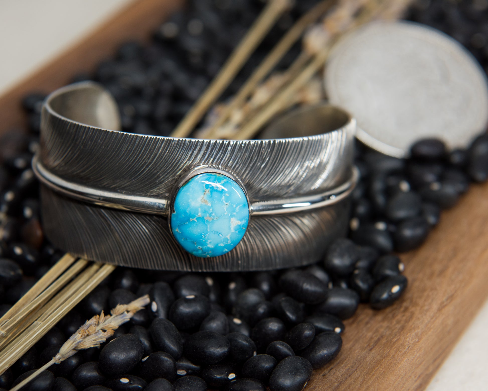 Kingman turquoise stamped feather cuff, worn view