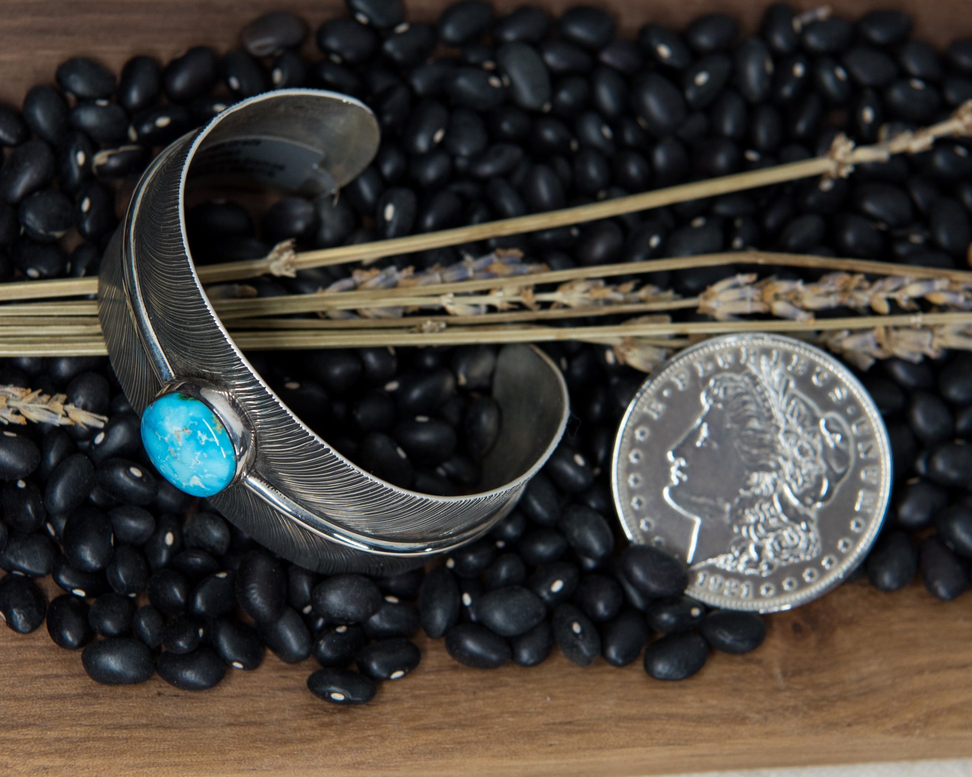 Kingman turquoise stamped feather cuff, close-up of stamping