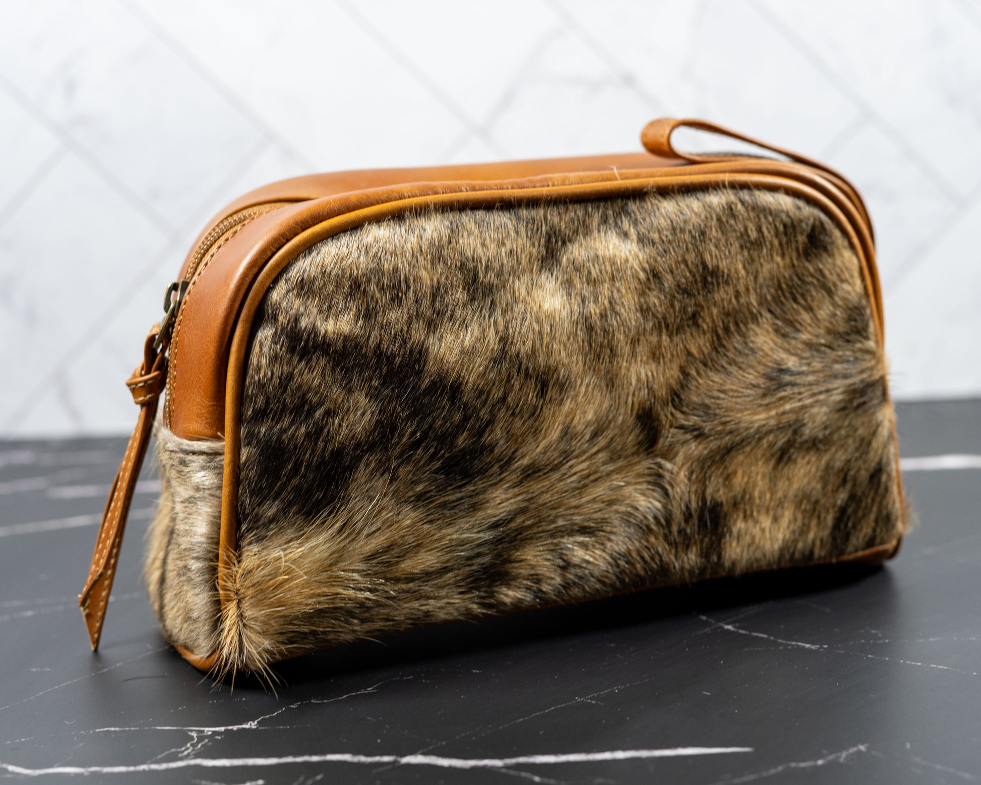 Cowhide leather Dopp kit travel bag, close-up of hide pattern