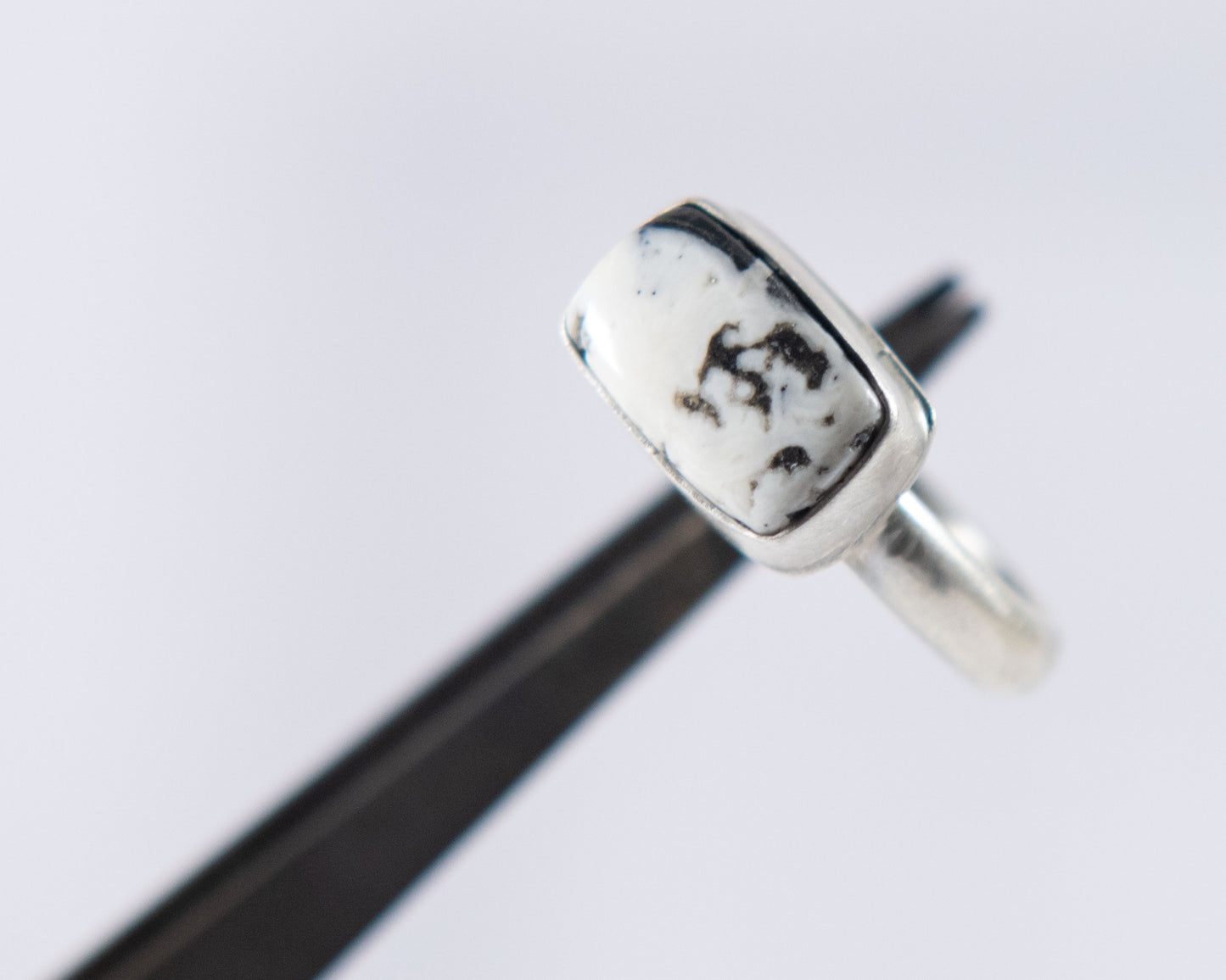 Black and white stacker ring by P. Yazzie, worn view