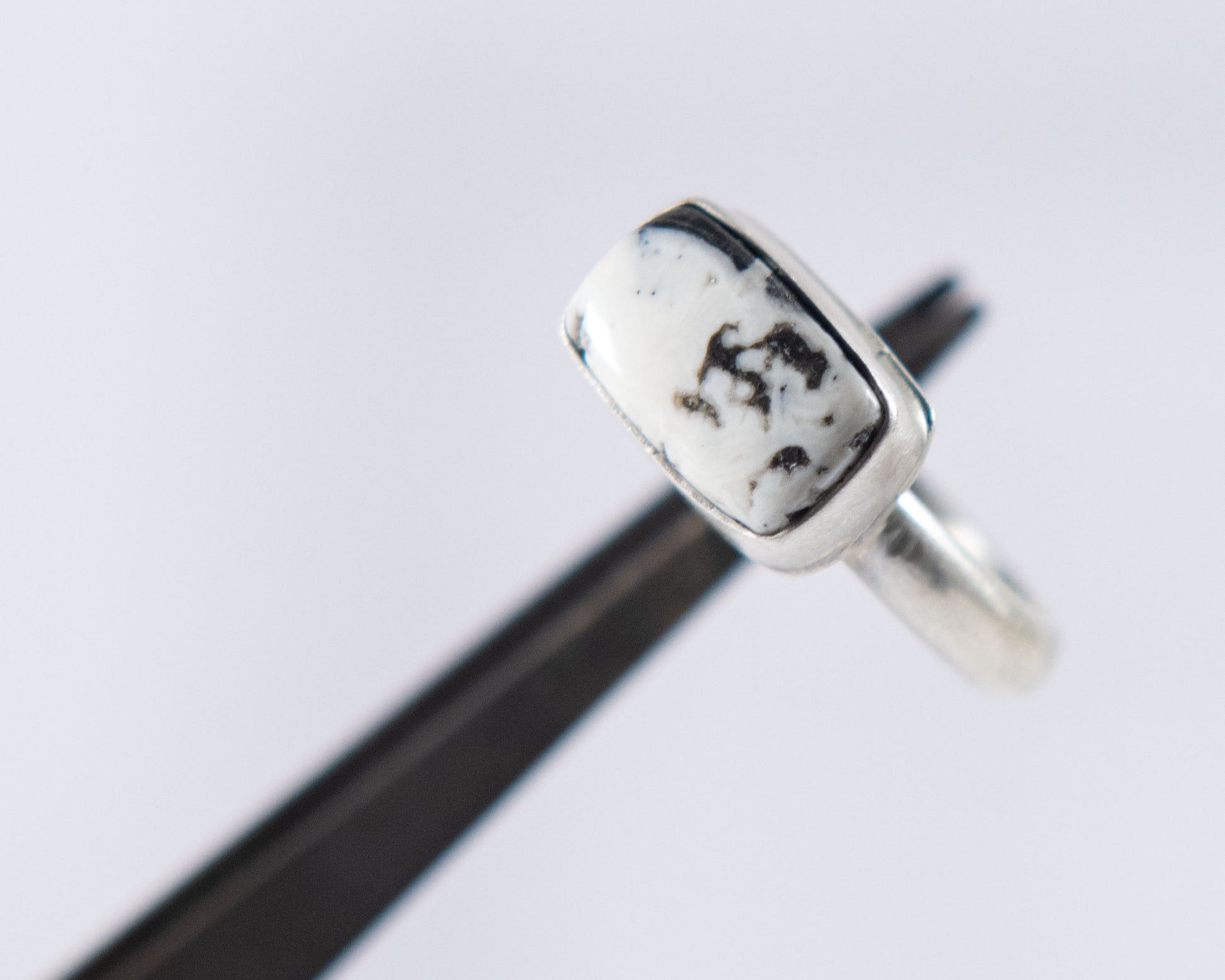 Black and white stacker ring by P. Yazzie, worn view